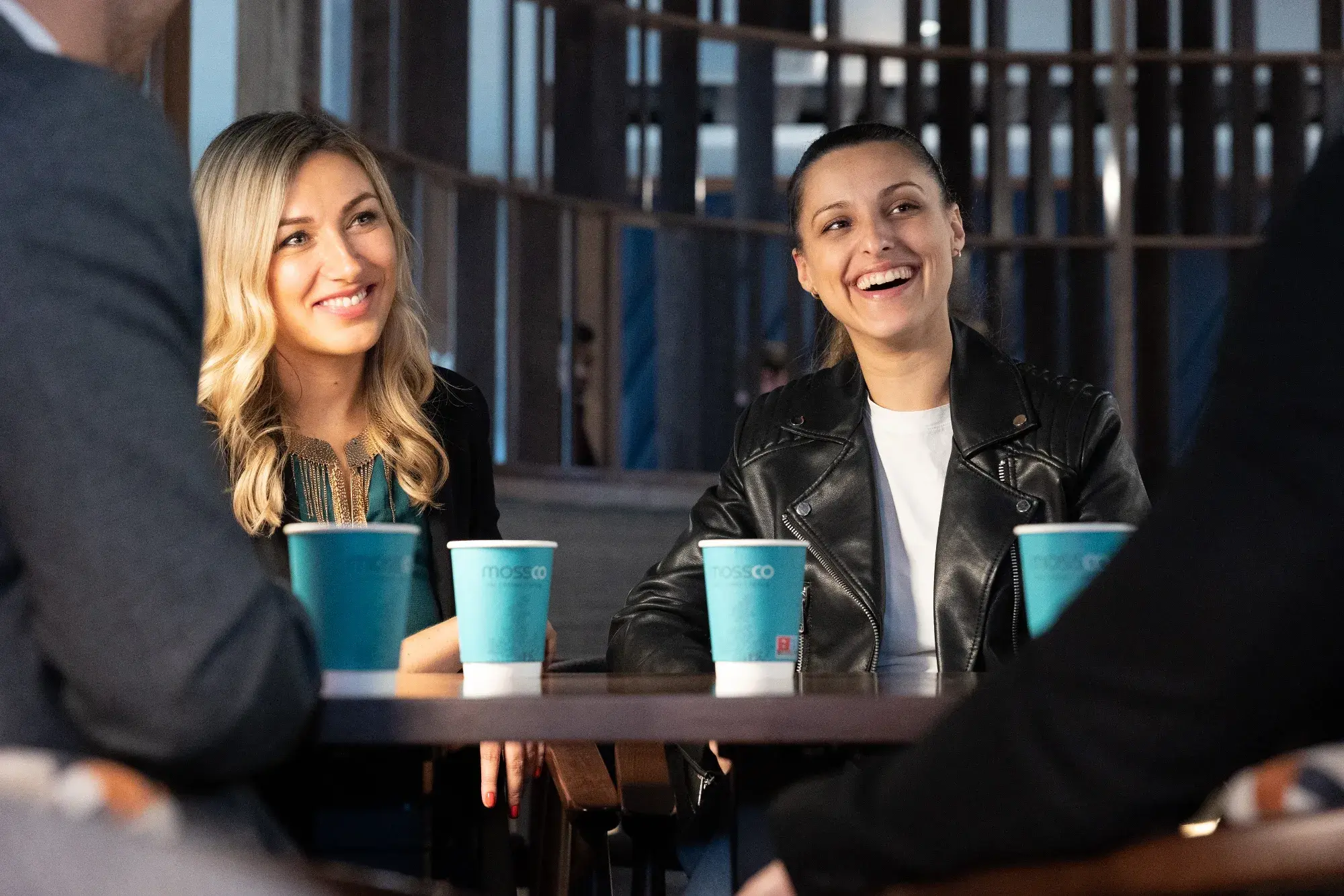 Two guests enjoying Mossco branded coffee cups together